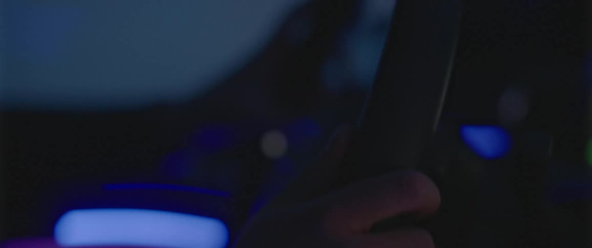 Mans hands holds steering wheel to control the direction that the vehicle goes in