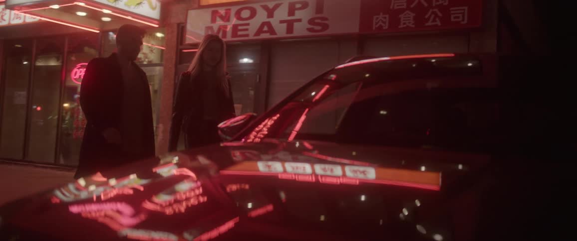 Young couple exit a restaurant and enters a car parked outside