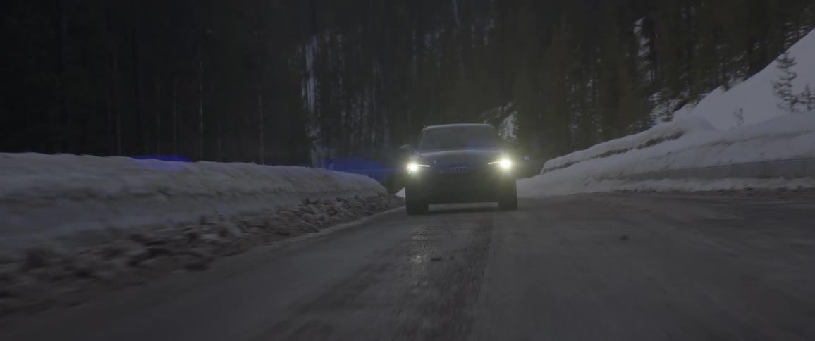 A car is driving on the icy road