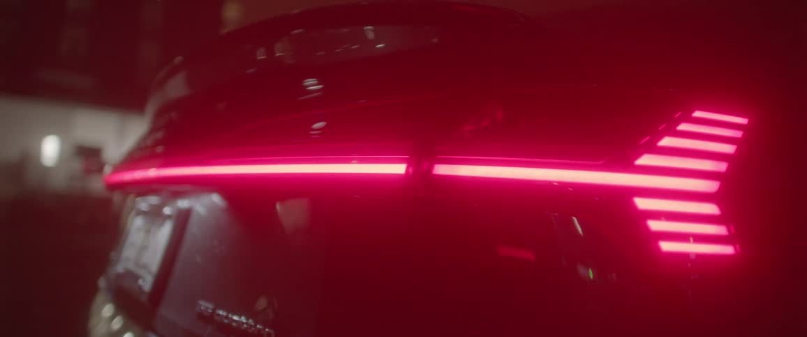 Dark grey audis rear lamps at night