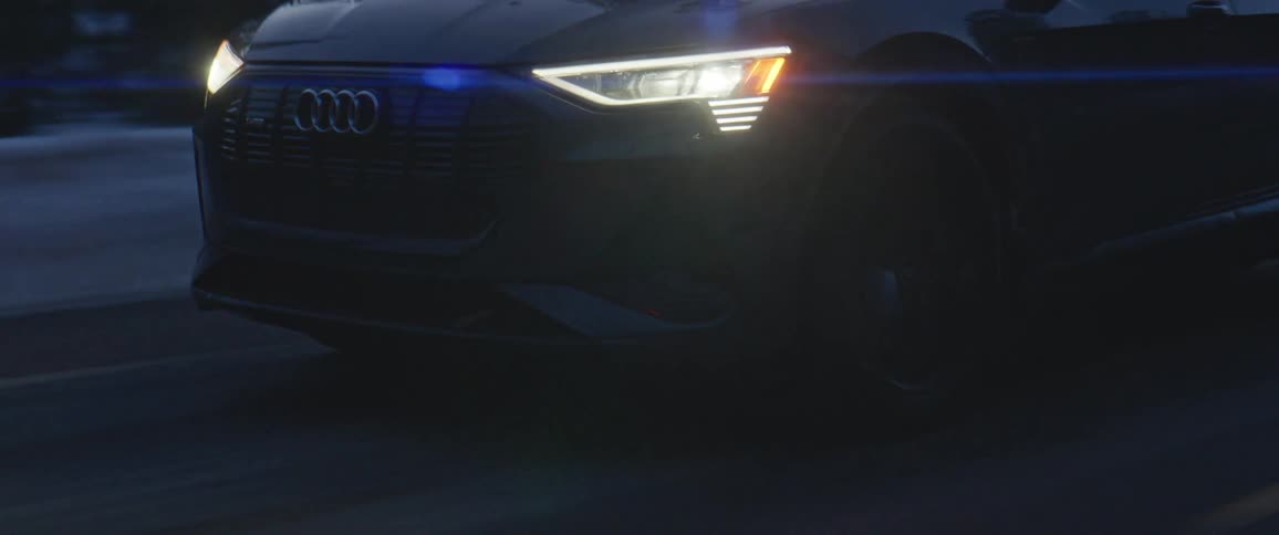 A car is driving on a road at night in winter
