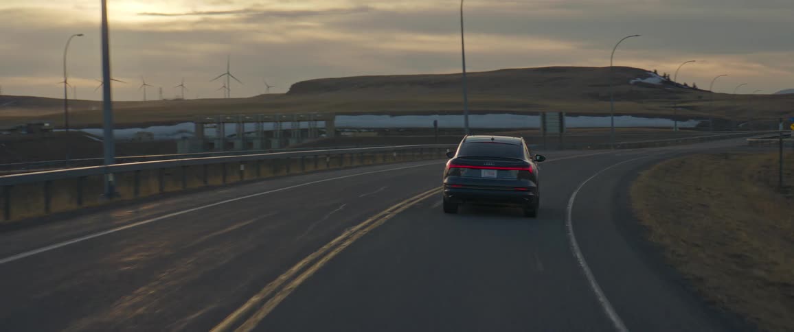 A view of a car driving down a road