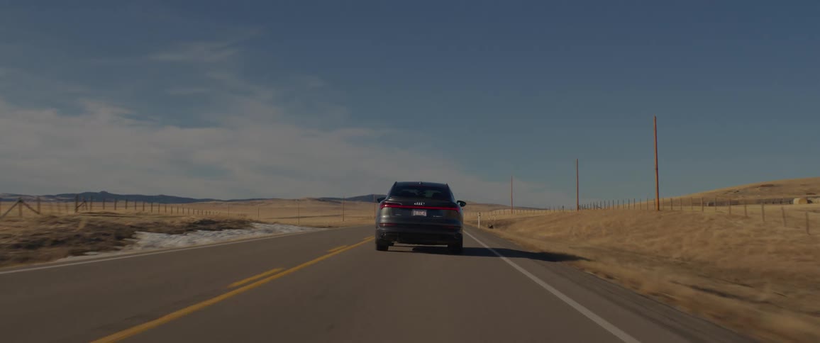 A view of a car driving down a road