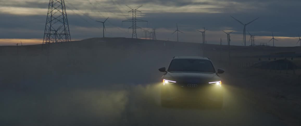 A view of a car driving off road in the dirt