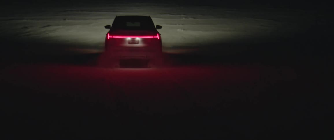 A vehicle driving on a snowy field