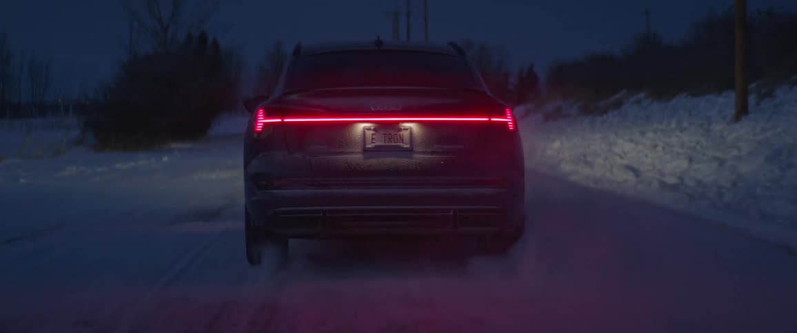 A car driving on a snowy rural road