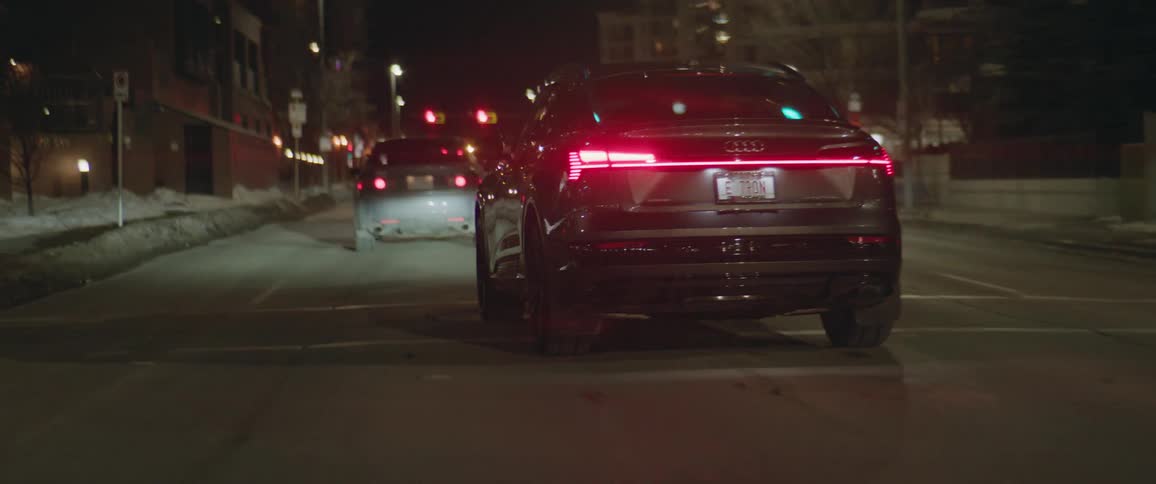 A car changes lanes as it drives down a city street