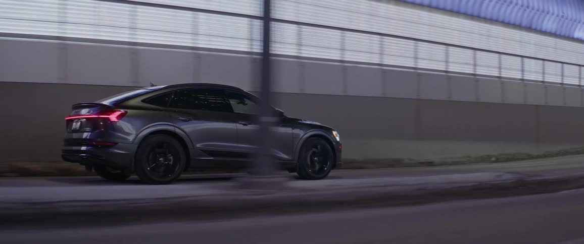 Car driving out of a tunnel in the city downtown at night
