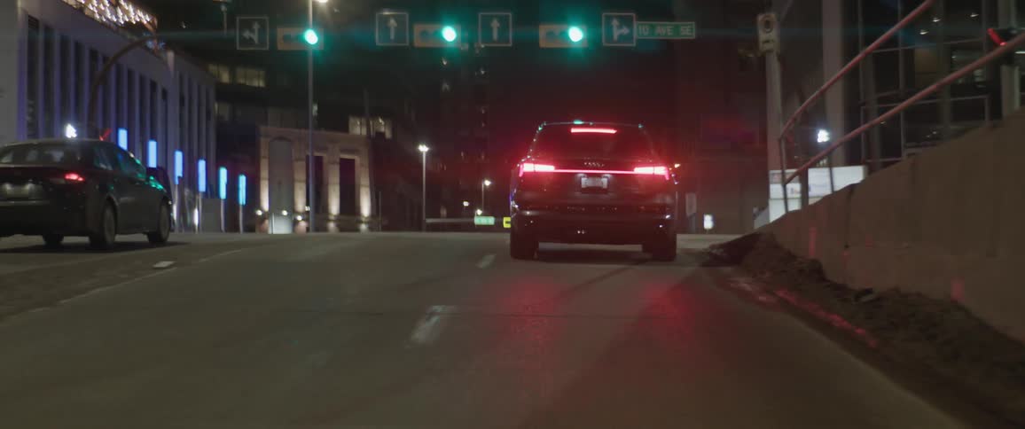 Car driving on the city streets at night