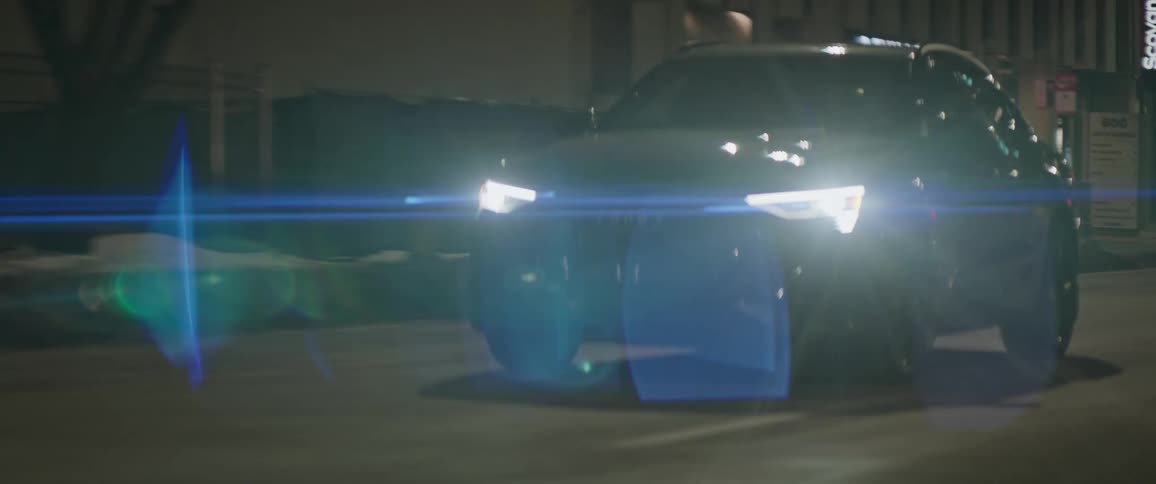 Dark grey audi car travels on city highway at night