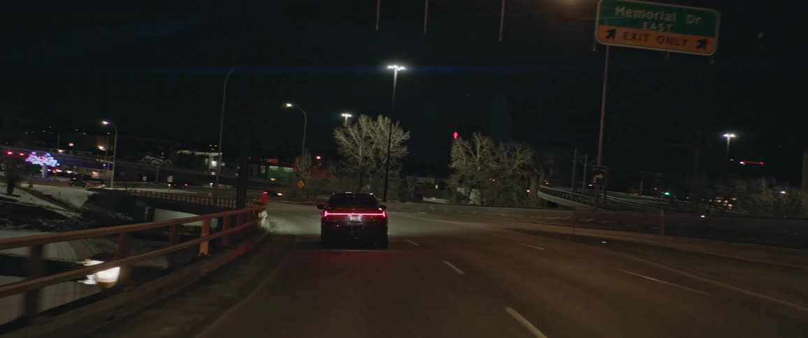 Car driving on the highway into the city at night