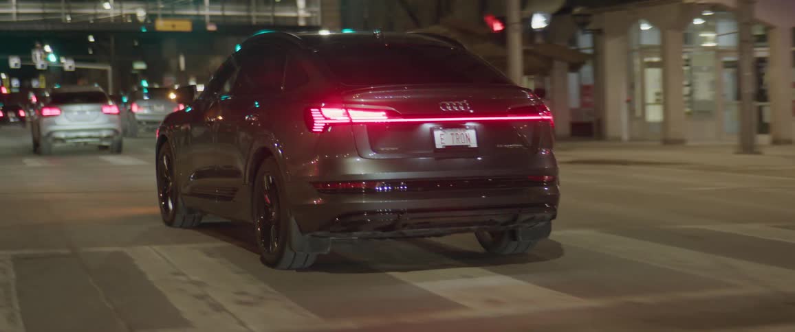 Audi car indicates left and drives along the road in the city