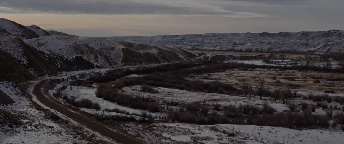 Mountain road in the countryside next to a valley at winter