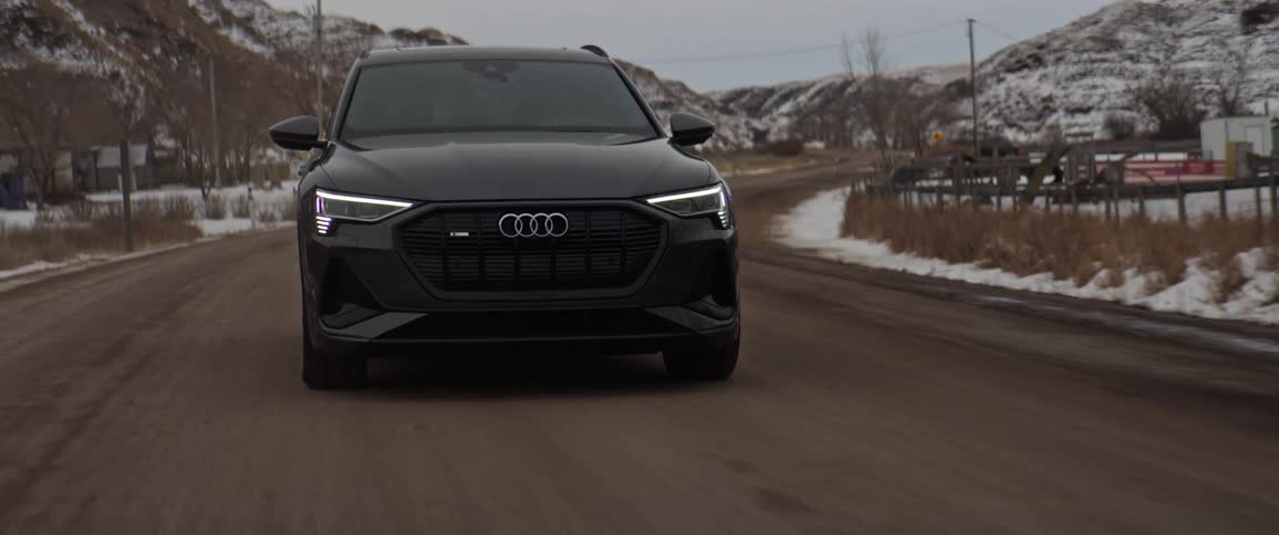 A car driving down a road during the middle of the winter