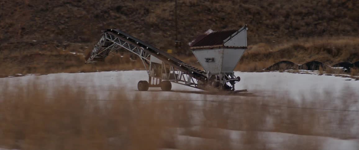 Farming equipment parked on a field covered in snow