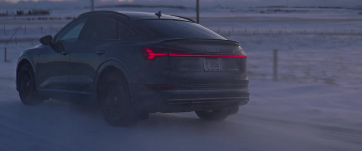 A car driving outdoors on a snowy road