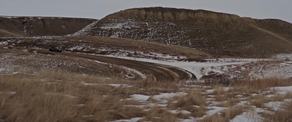 A car drives on an offroad trail in the winter