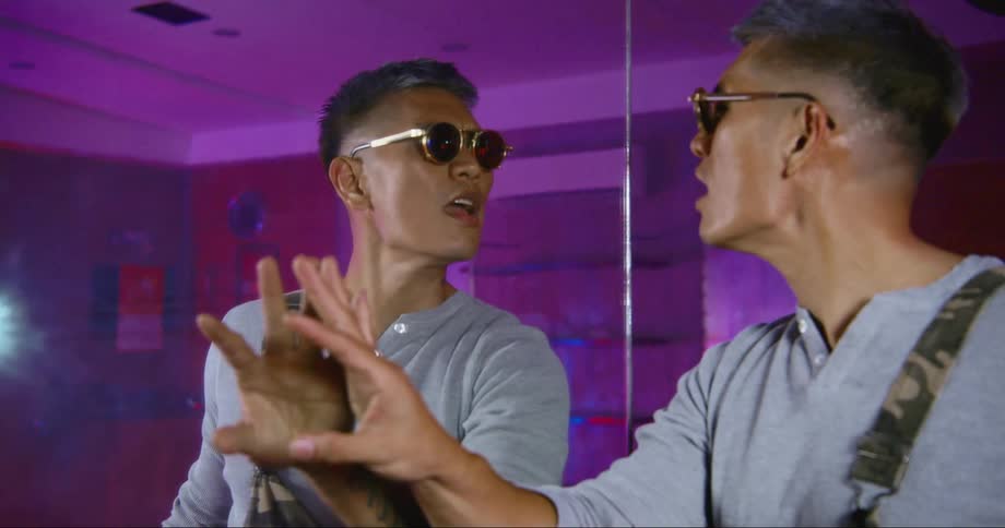 Hip hop dancer rehearsing in a studio filled with neon lights