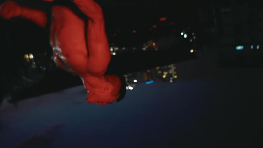 A man dancing outdoors at night