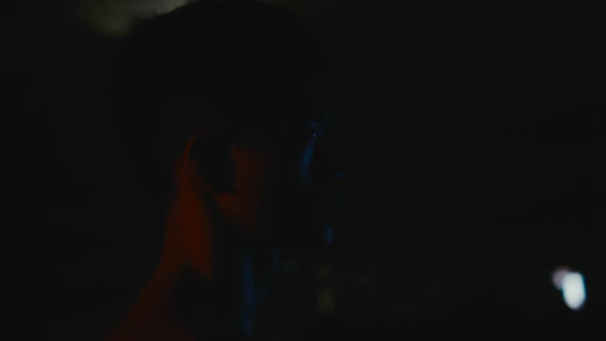 Strong muscular shirtless asian man standing near the city at night