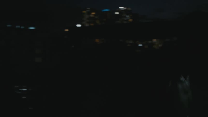 Asian strong muscular shirtless man screaming violently near the city at night
