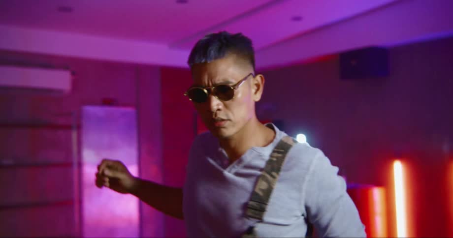 Hip hop dancer rehearsing in a studio filled with neon lights