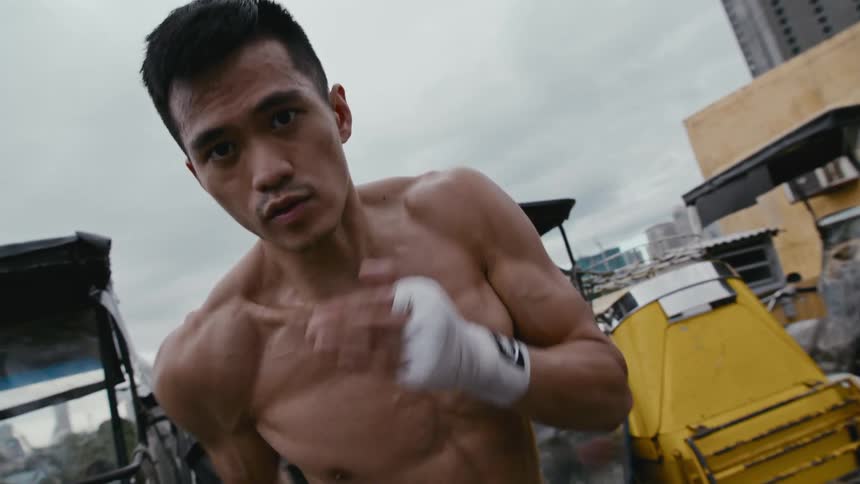 Young muscular shirtless man shadow boxing in front of the camera