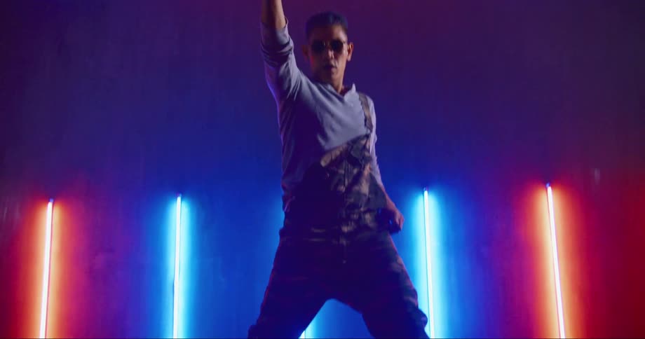 Hip hop dancer rehearsing in a studio filled with neon lights