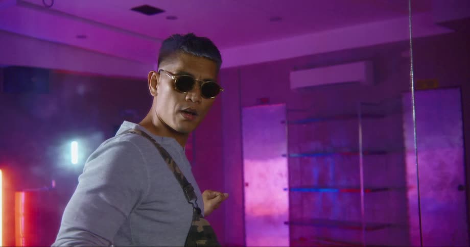 Hip hop dancer rehearsing in a studio filled with neon lights