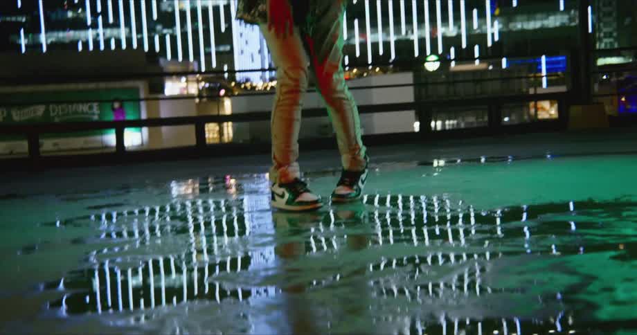 A man dancing outdoors in a city