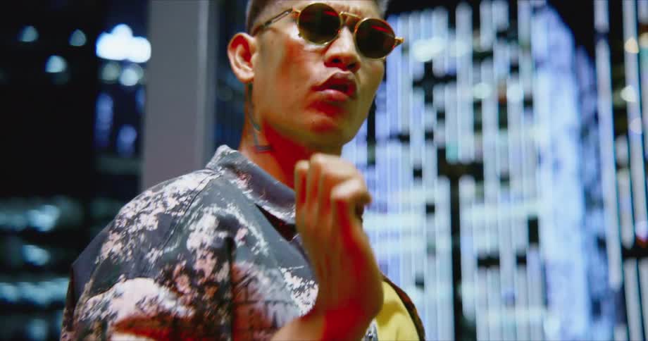 Hiphop Dancer Rehearsing in the Middle of the City with buildings in the background looking at the camera