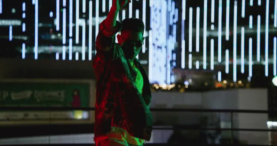 Dancer rehearses on a rooftop with the city skyline in background