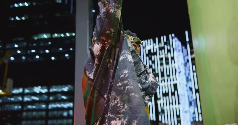 A man is dancing outside at night