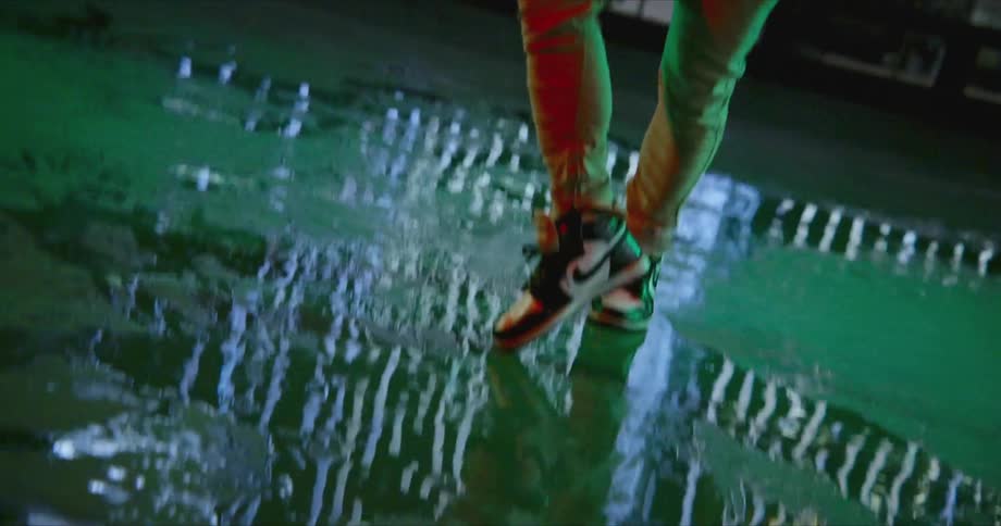 A man dancing outdoors at night