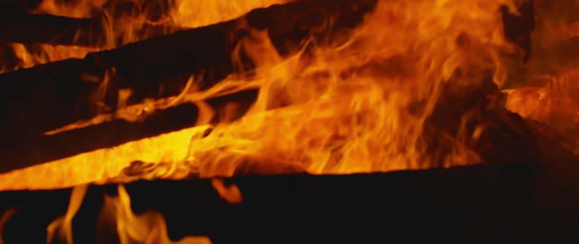 Wood burning with fire light and smoke