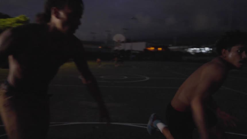 Two young men playing a casual game of basketball
