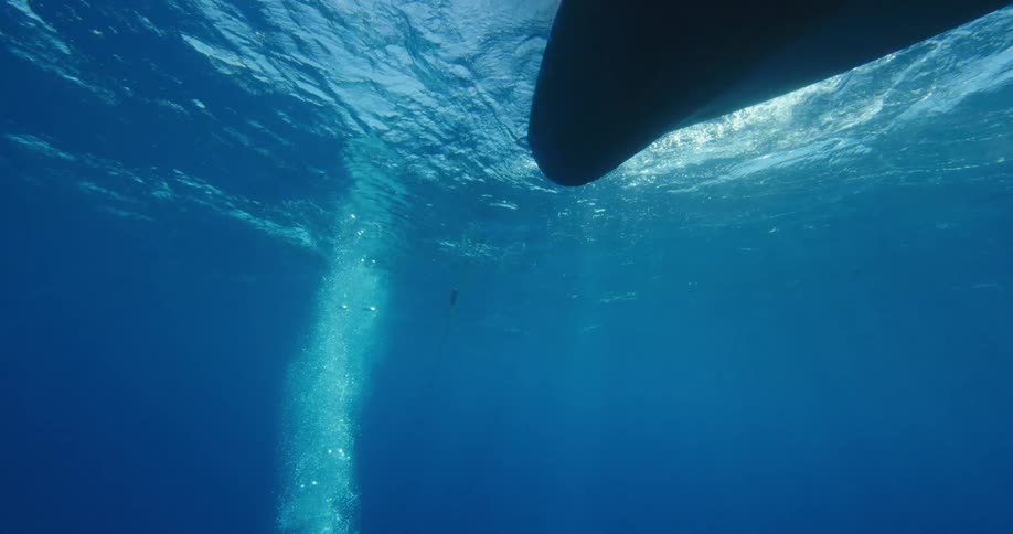 A diver is rising towards his ship