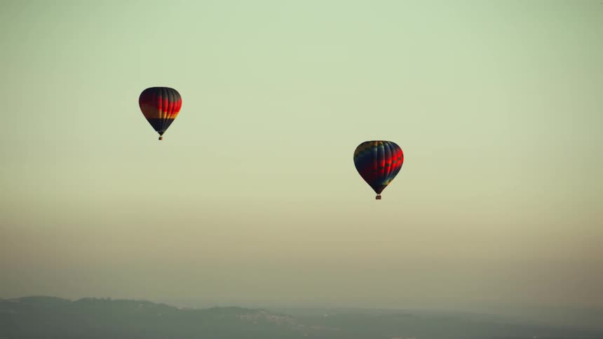 Two hot air balloons floating high in the sky