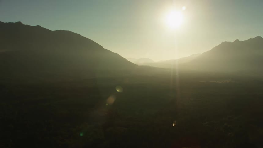 Bright sunlight shines down on a canyon