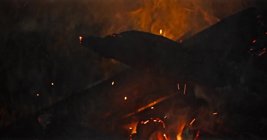 Wood burning with fire light and smoke