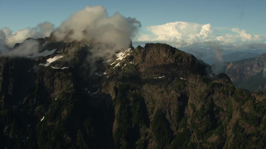 Snow covers the peak of tall mountain ranges