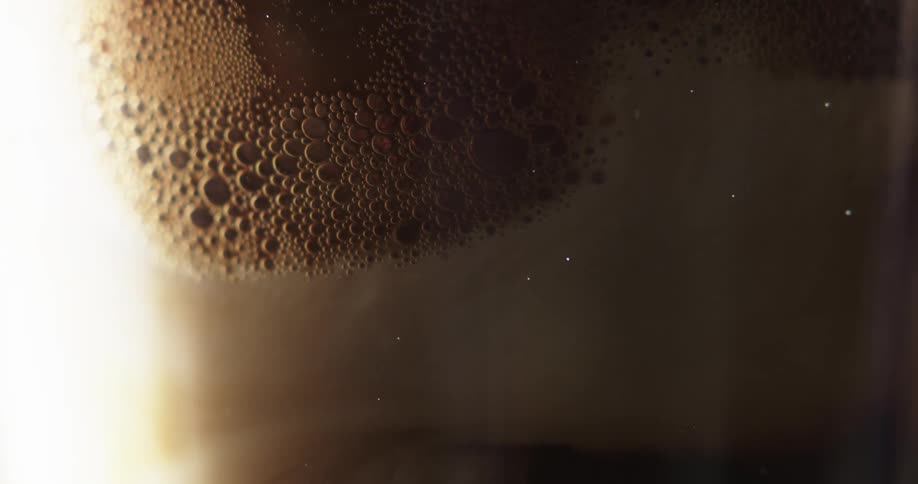 Close up of bubbles dissipating from a chocolate drink
