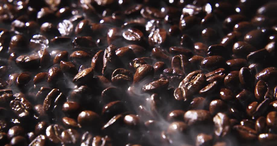 Smoke aroma rises from roasted coffee beans
