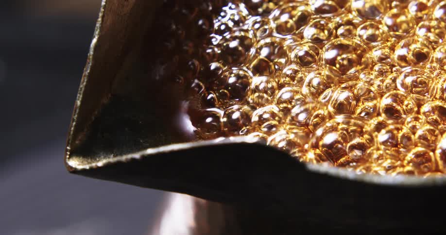 Liquid is boiling in a pot indoors