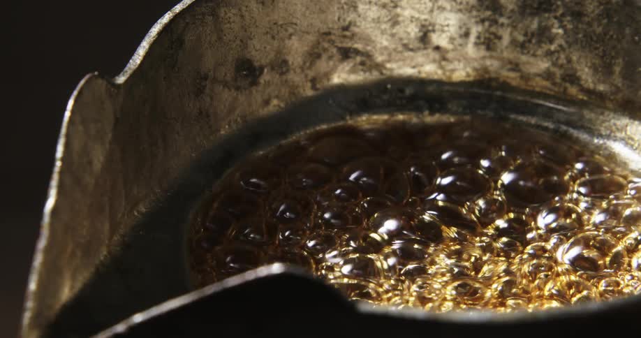 Bubbles boil in liquid as it heats