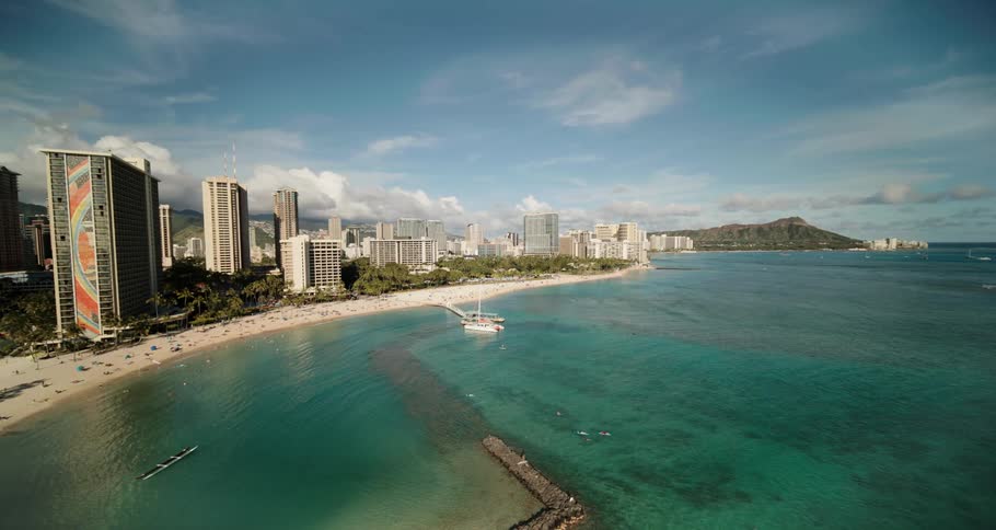 Aerial shot of a coastline with multiple tall buildings in sight