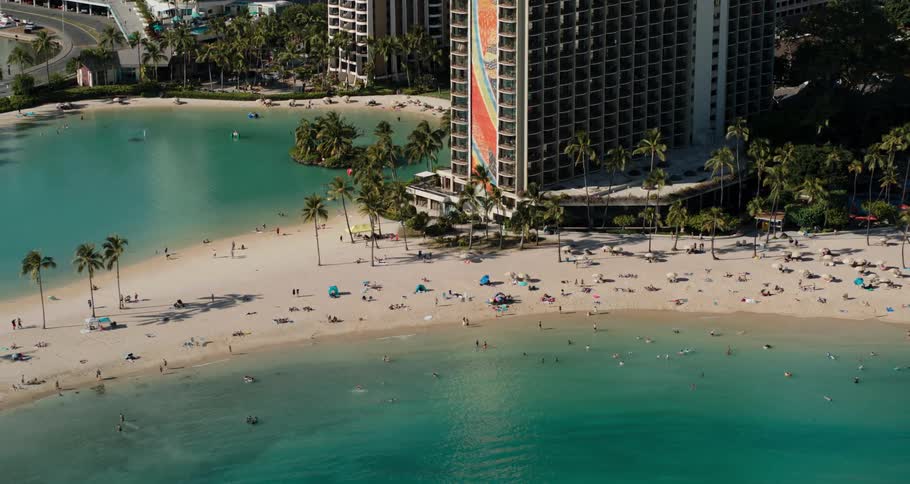 Aerial view of a beach next to a city is displayed