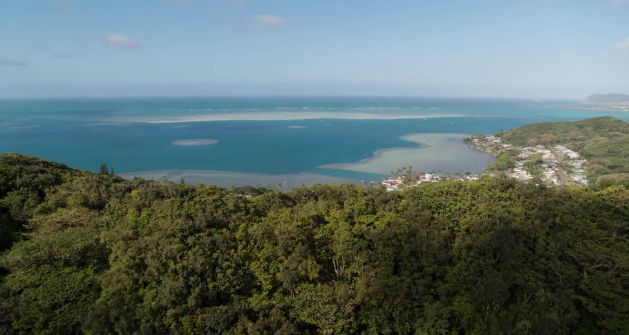 Small coastal town near the mountains in front of the blue ocean waters
