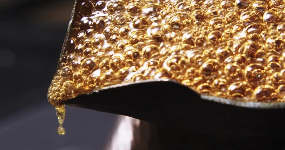 Bubbles bounce as coffee boils in a pot