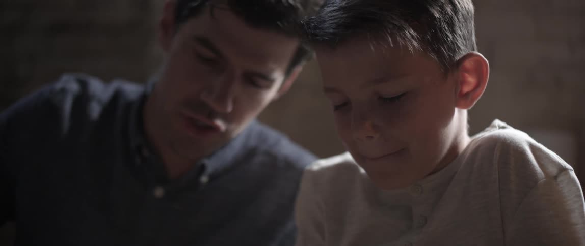 A man and child are talking together